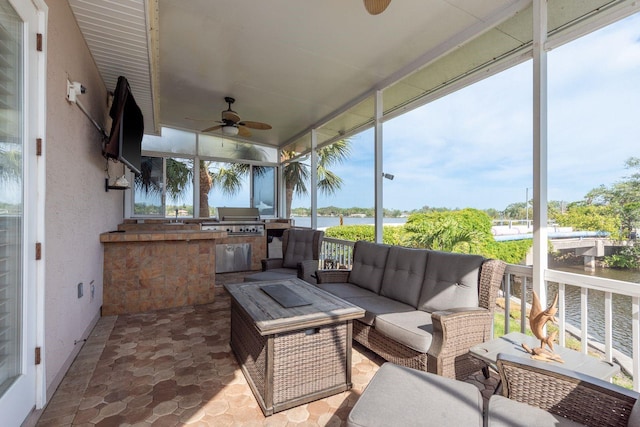 sunroom featuring area for grilling, a ceiling fan, and outdoor lounge area