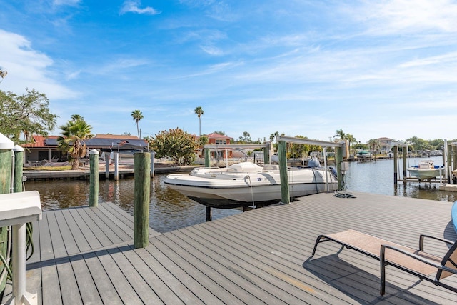 dock area with a water view and boat lift