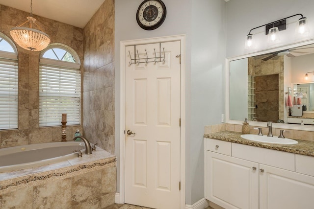 bathroom with vanity, a ceiling fan, and a bath