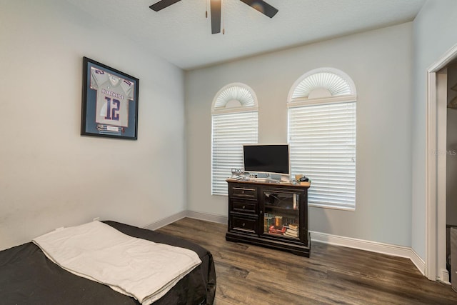 bedroom with wood finished floors, a ceiling fan, and baseboards