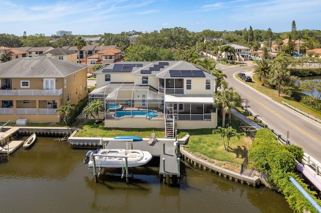 birds eye view of property with a residential view and a water view