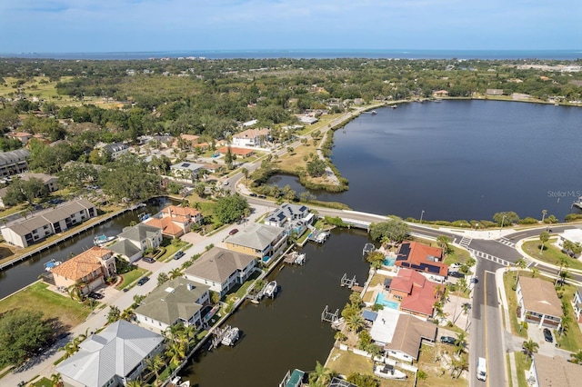 birds eye view of property with a water view and a residential view