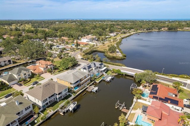 birds eye view of property with a residential view and a water view