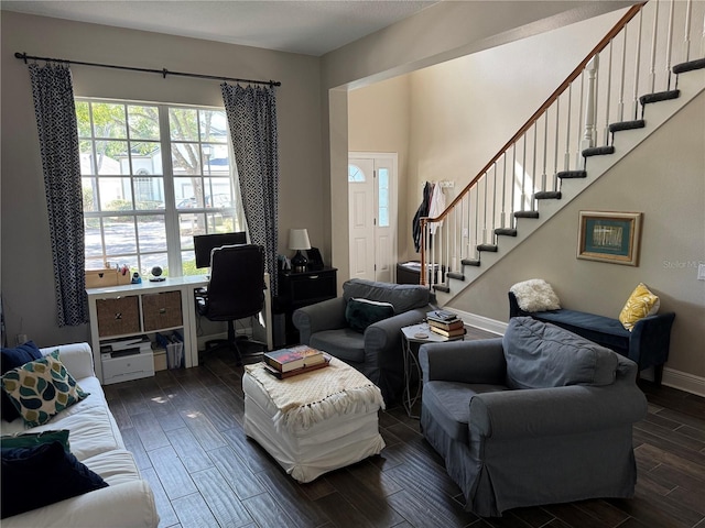 living room featuring stairs, wood finish floors, and baseboards