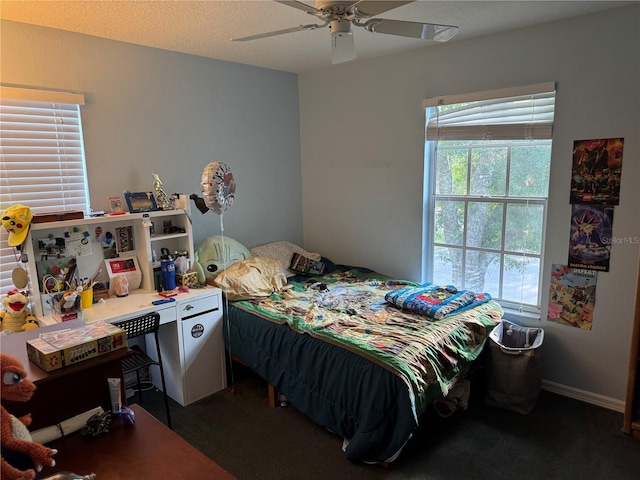 bedroom featuring dark colored carpet and ceiling fan
