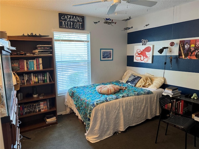 bedroom featuring carpet floors, a ceiling fan, a textured ceiling, and multiple windows
