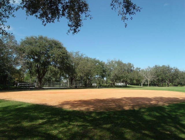 view of property's community featuring a lawn and volleyball court