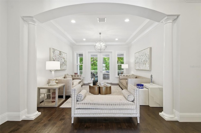 2604 S Bryant Cir, Tampa, FL 33629 - living room with arched walkways, dark wood-type flooring, a tray ceiling, ornate columns, and recessed lighting