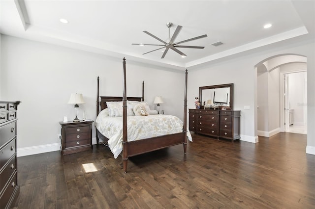 2604 S Bryant Cir, Tampa, FL 33629 - bedroom featuring a raised ceiling, arched walkways, dark wood-style flooring, recessed lighting, and baseboards