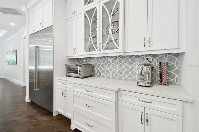 2604 S Bryant Cir, Tampa, FL 33629 - kitchen with stainless steel built in refrigerator, backsplash, white cabinetry, dark wood-style floors, and glass insert cabinets