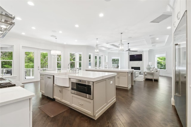 2604 S Bryant Cir, Tampa, FL 33629 - kitchen with a spacious island, a sink, open floor plan, appliances with stainless steel finishes, and recessed lighting