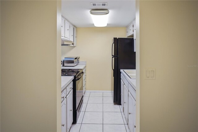 kitchen with black appliances, visible vents, white cabinetry, light countertops, and a toaster