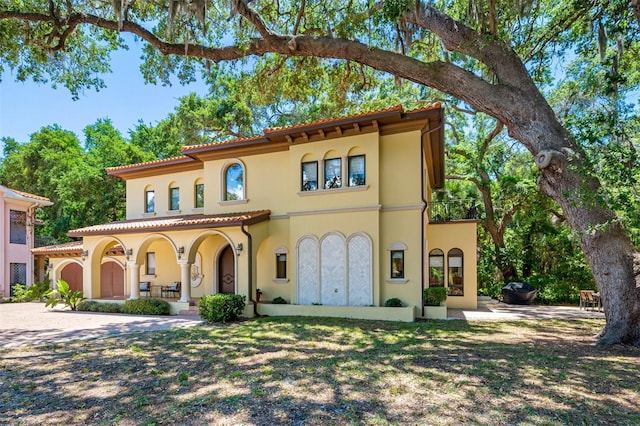 1966 Freedom Dr, Clearwater, FL 33755 - mediterranean / spanish-style home with stucco siding, covered porch, and a tiled roof