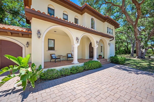 1966 Freedom Dr, Clearwater, FL 33755 - view of front of property with stucco siding, a porch, and a tile roof