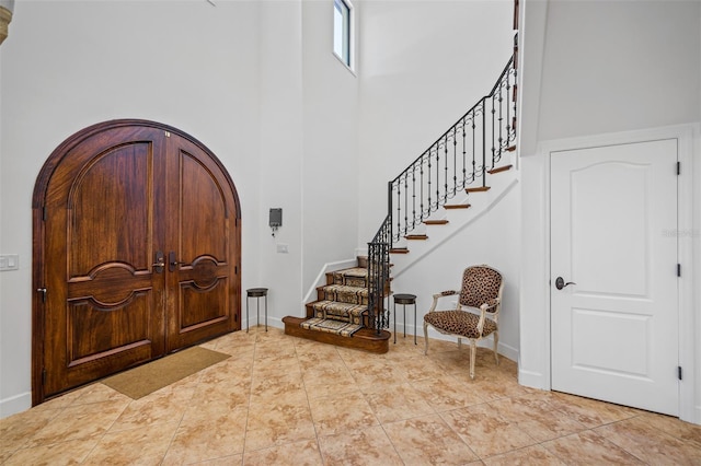 1966 Freedom Dr, Clearwater, FL 33755 - entrance foyer with a high ceiling, stairway, and baseboards