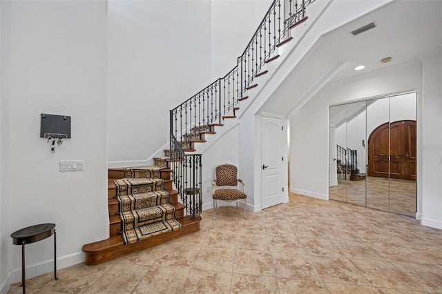 1966 Freedom Dr, Clearwater, FL 33755 - stairs with a towering ceiling, baseboards, tile patterned flooring, and recessed lighting