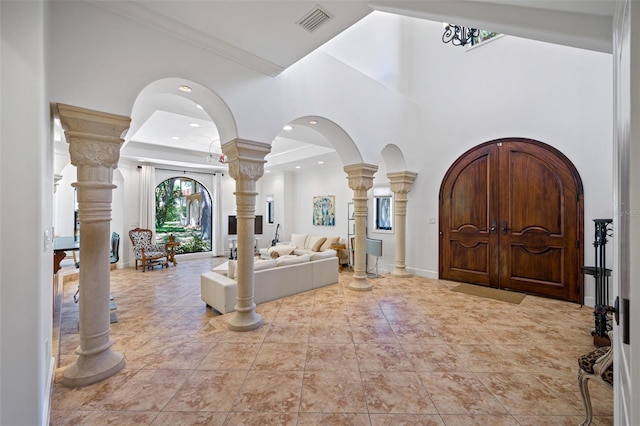 1966 Freedom Dr, Clearwater, FL 33755 - foyer with decorative columns, arched walkways, ornamental molding, a towering ceiling, and baseboards
