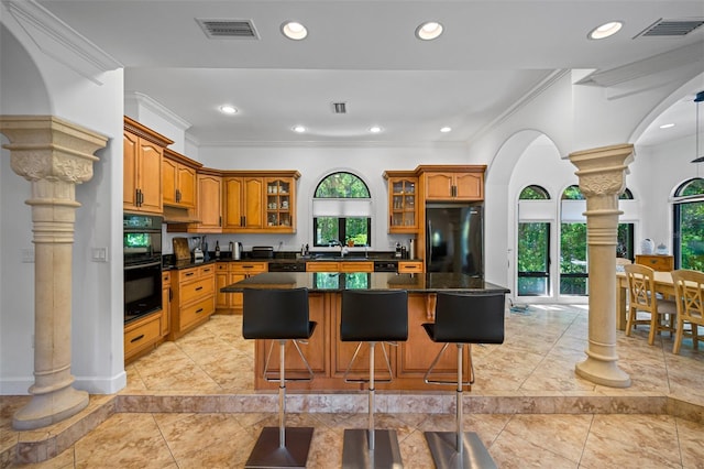1966 Freedom Dr, Clearwater, FL 33755 - kitchen featuring black appliances, decorative columns, ornamental molding, glass insert cabinets, and healthy amount of natural light