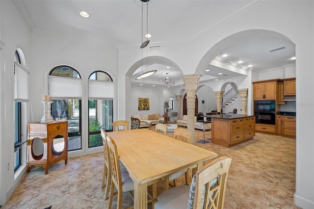1966 Freedom Dr, Clearwater, FL 33755 - dining space with ornate columns, crown molding, arched walkways, recessed lighting, and light tile patterned floors