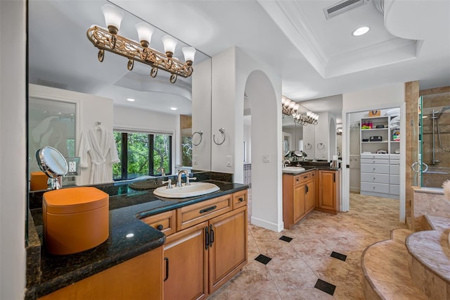 1966 Freedom Dr, Clearwater, FL 33755 - bathroom with a tray ceiling, a shower stall, two vanities, recessed lighting, and ornamental molding