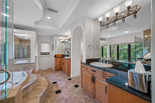 1966 Freedom Dr, Clearwater, FL 33755 - bathroom featuring a raised ceiling, a shower stall, crown molding, a garden tub, and two vanities