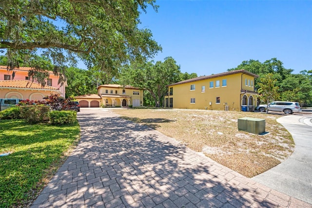 1966 Freedom Dr, Clearwater, FL 33755 - surrounding community with a yard and decorative driveway