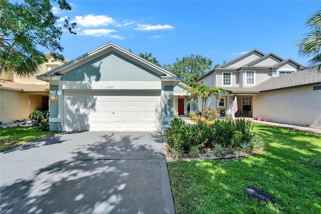 11932 Whisper Creek Dr, Riverview, FL 33569 - view of front of home featuring an attached garage, stucco siding, driveway, and a front yard