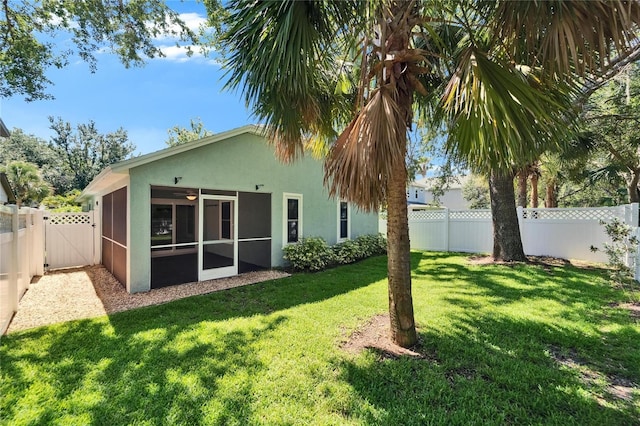 11932 Whisper Creek Dr, Riverview, FL 33569 - view of yard featuring a sunroom, a gate, and a ceiling fan