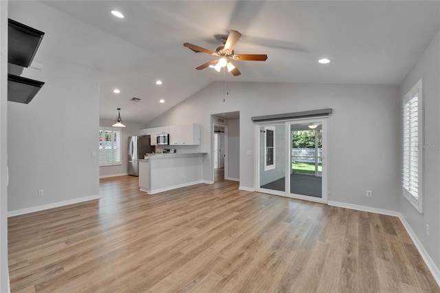 11932 Whisper Creek Dr, Riverview, FL 33569 - unfurnished living room with a ceiling fan, plenty of natural light, light wood-style flooring, vaulted ceiling, and recessed lighting