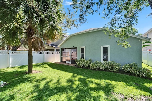 11932 Whisper Creek Dr, Riverview, FL 33569 - rear view of house featuring stucco siding and a sunroom