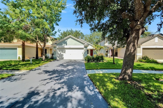 11932 Whisper Creek Dr, Riverview, FL 33569 - ranch-style home featuring stucco siding, a front yard, an attached garage, and driveway