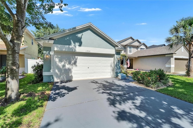11932 Whisper Creek Dr, Riverview, FL 33569 - view of front of house featuring driveway, a garage, and stucco siding