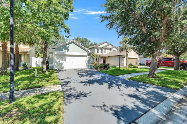 11932 Whisper Creek Dr, Riverview, FL 33569 - view of front of property with stucco siding, asphalt driveway, and an attached garage