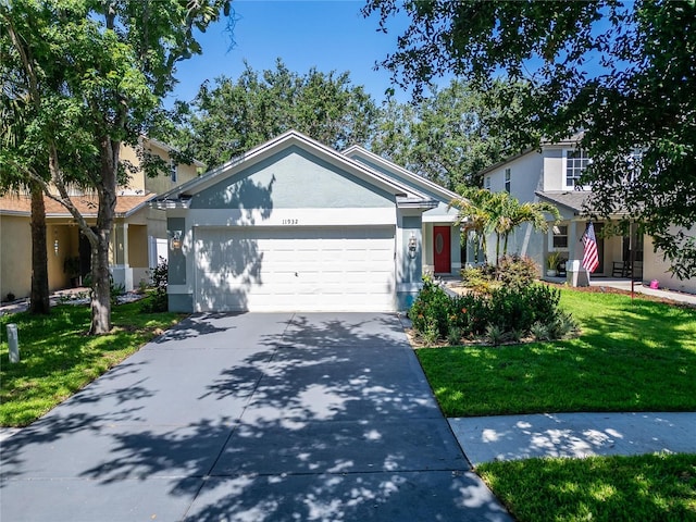 11932 Whisper Creek Dr, Riverview, FL 33569 - view of front facade featuring an attached garage, a front yard, driveway, and stucco siding