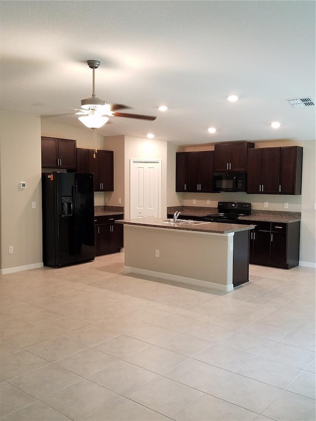 kitchen featuring baseboards, light tile patterned floors, black appliances, and dark brown cabinets