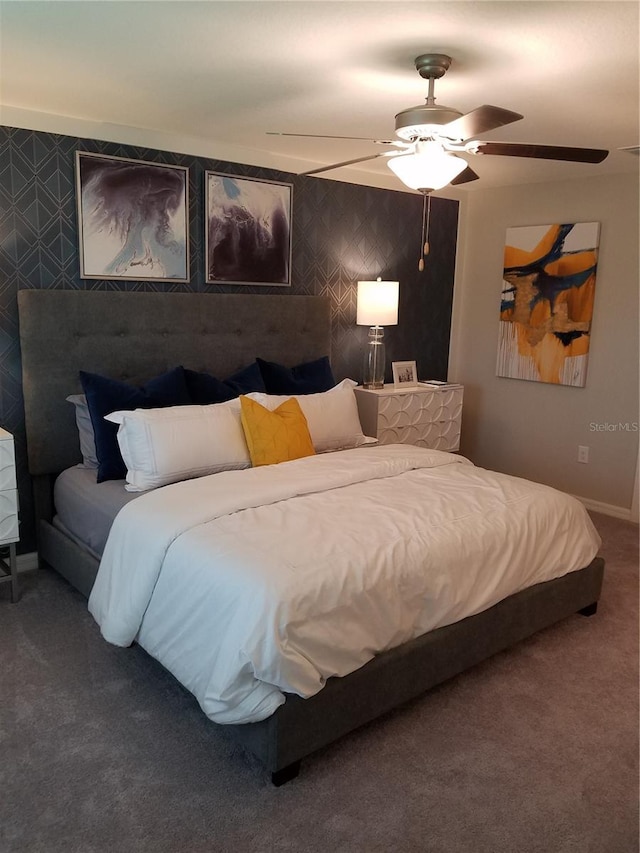 carpeted bedroom with baseboards and ceiling fan