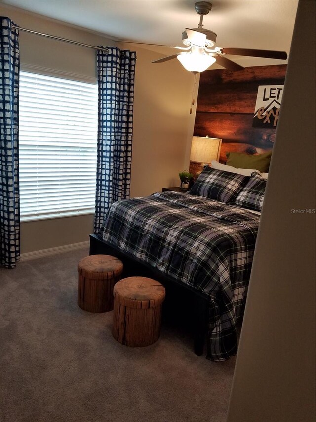 carpeted bedroom with baseboards and ceiling fan