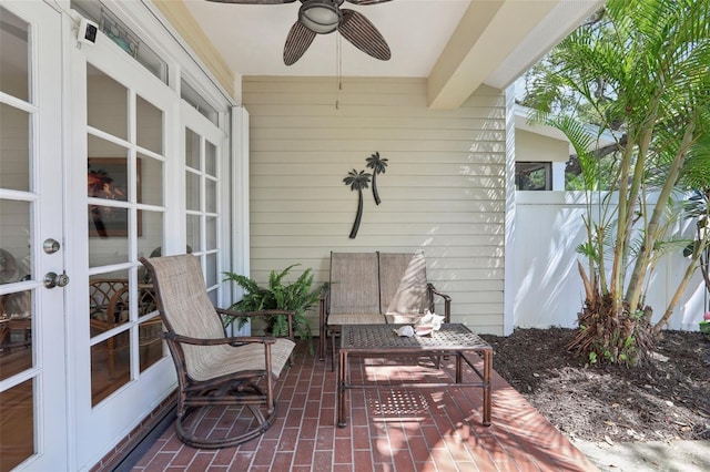 view of patio / terrace with fence, french doors, and ceiling fan