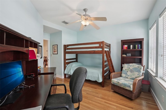 bedroom with visible vents, wood finished floors, ceiling fan, and multiple windows