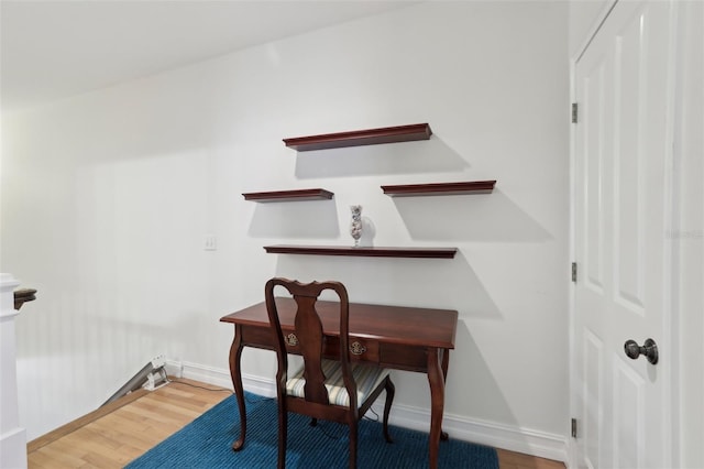 office area featuring wood finished floors and baseboards