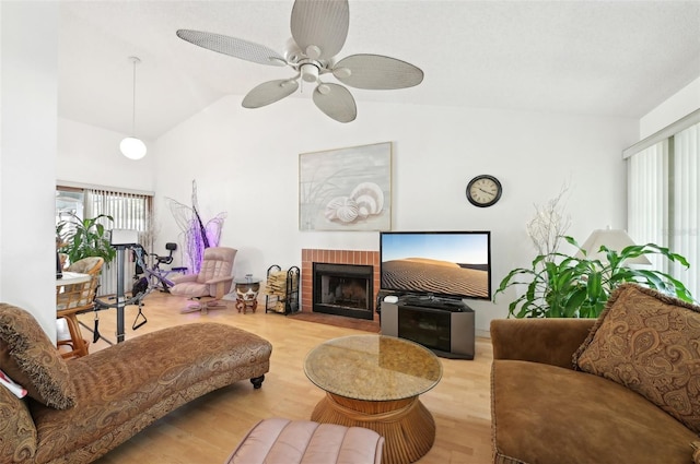 3093 Woodpine Cir, Sarasota, FL 34231 - living area featuring a ceiling fan, a brick fireplace, wood finished floors, and vaulted ceiling