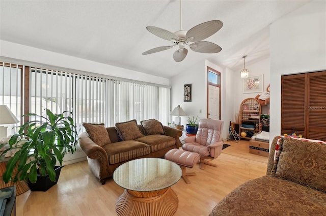 3093 Woodpine Cir, Sarasota, FL 34231 - living area featuring light wood-style flooring, ceiling fan, and vaulted ceiling