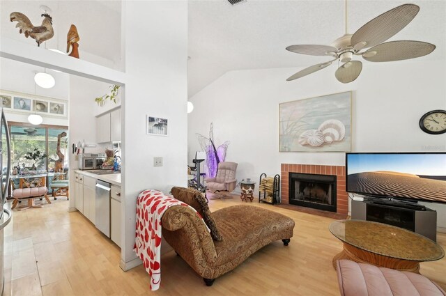 3093 Woodpine Cir, Sarasota, FL 34231 - living room featuring a brick fireplace, light wood-style flooring, ceiling fan, and high vaulted ceiling