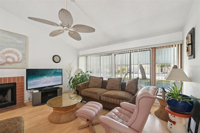 3093 Woodpine Cir, Sarasota, FL 34231 - living area with wood finished floors, a ceiling fan, a brick fireplace, and lofted ceiling