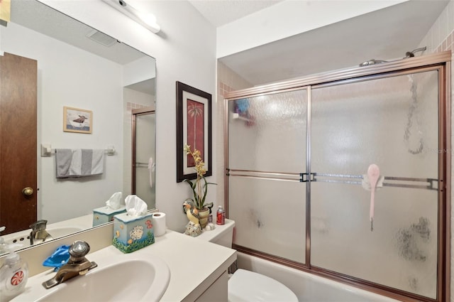 3093 Woodpine Cir, Sarasota, FL 34231 - full bathroom featuring vanity, bath / shower combo with glass door, and toilet