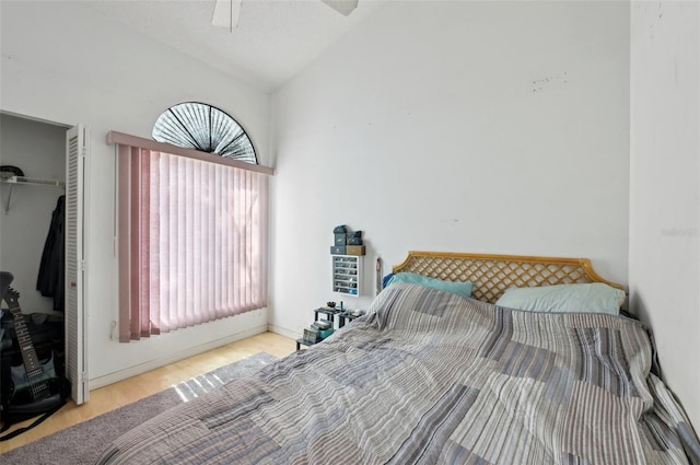 3093 Woodpine Cir, Sarasota, FL 34231 - bedroom with a closet, lofted ceiling, wood finished floors, baseboards, and a ceiling fan