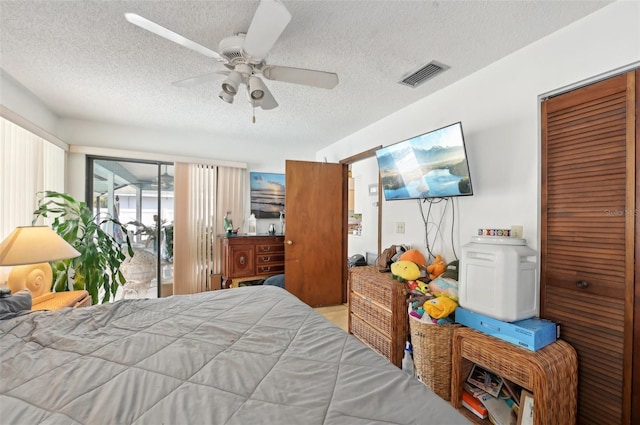 3093 Woodpine Cir, Sarasota, FL 34231 - bedroom with visible vents, a ceiling fan, a textured ceiling, and access to outside