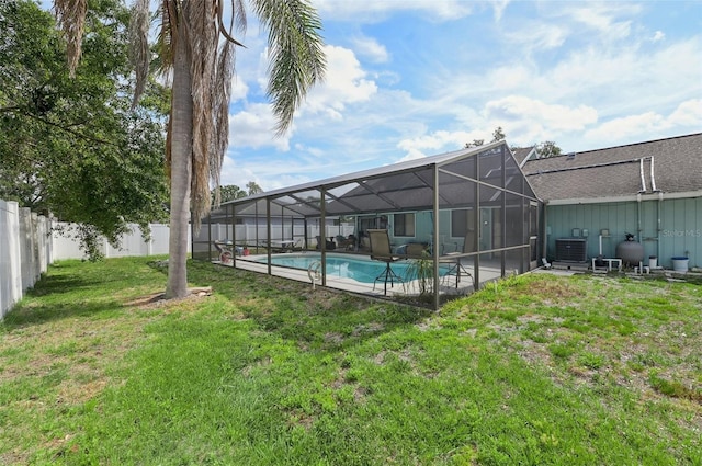 3093 Woodpine Cir, Sarasota, FL 34231 - exterior space featuring glass enclosure, central AC, a fenced in pool, a fenced backyard, and a yard