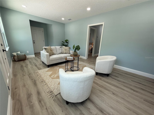 110 Kenwood Ave, Clearwater, FL 33755 - living room featuring light wood-type flooring, baseboards, a textured ceiling, and recessed lighting