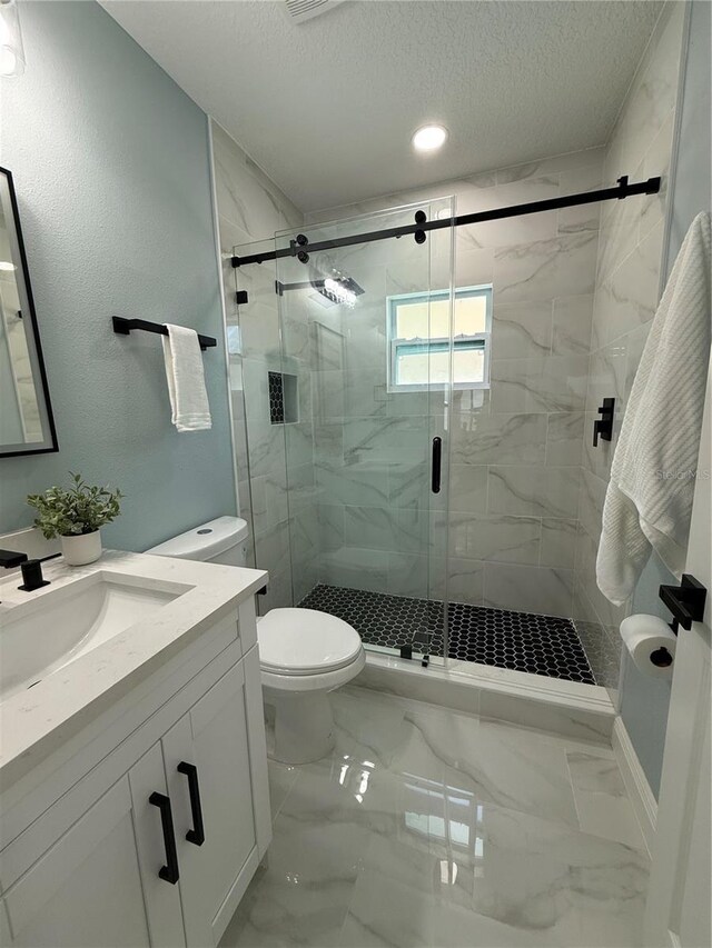 110 Kenwood Ave, Clearwater, FL 33755 - full bathroom featuring vanity, toilet, a textured ceiling, a marble finish shower, and marble finish flooring